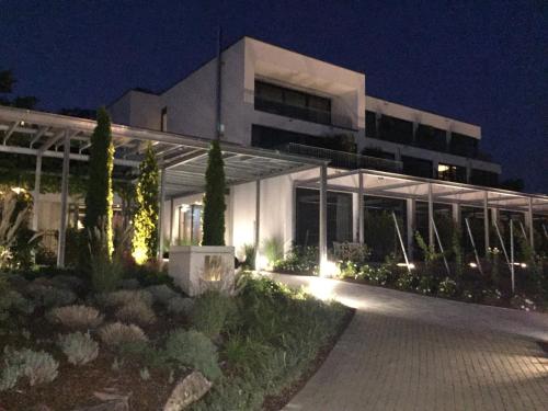 a large white building with lights in the night at Heitlinger Hof in Tiefenbach