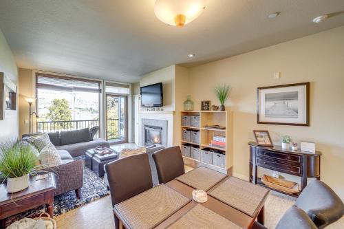 a living room with a couch and a table at Walk to the Lake Chelan Condo with Mtn Views! in Chelan