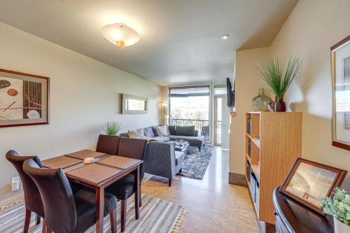 a living room with a table and a couch at Walk to the Lake Chelan Condo with Mtn Views! in Chelan