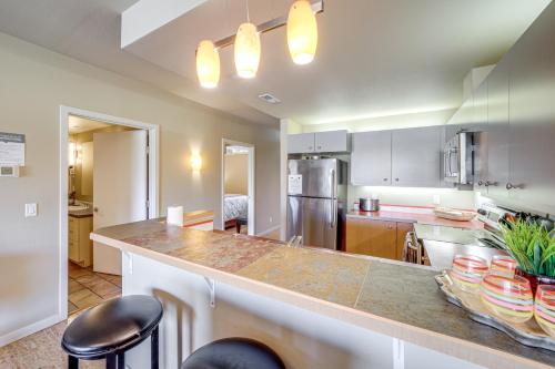 a kitchen with a large counter with stools at Walk to the Lake Chelan Condo with Mtn Views! in Chelan