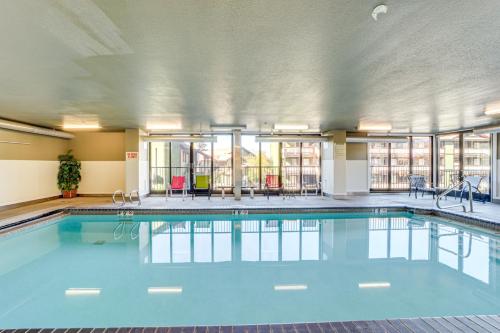 a swimming pool with blue water in a building at Walk to the Lake Chelan Condo with Mtn Views! in Chelan