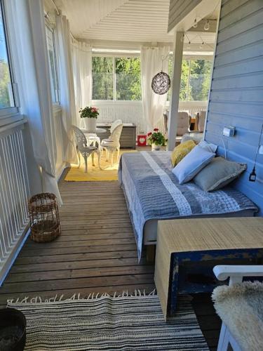 a bedroom with a bed and a table and chairs at RoseGarden - art&nature - talo luonnossa in Espoo