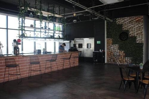 a person is standing at a counter in a restaurant at Ecovergel Santa Lucia in Monterrey