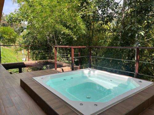 a jacuzzi tub sitting on top of a deck at Pachakuti Eco-vida Hotel in Caicedonia