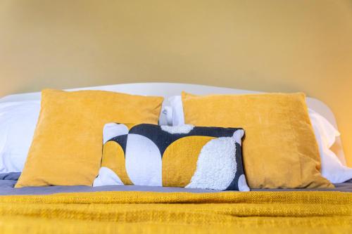a bed with two pillows on it with yellow pillows at Al CASTELLO AVEZZANO in Avezzano