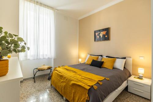 a bedroom with a bed with a yellow blanket on it at Al CASTELLO AVEZZANO in Avezzano