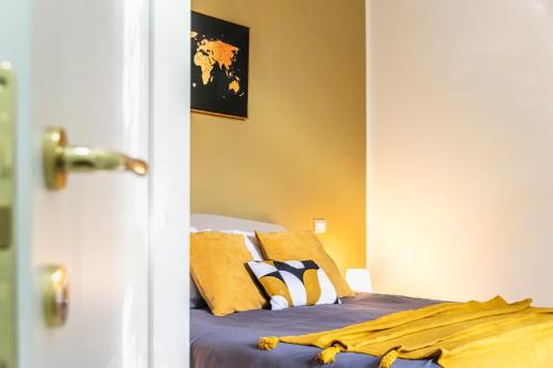a bedroom with a bed with yellow walls at Al CASTELLO AVEZZANO in Avezzano