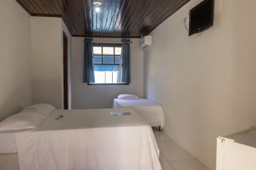 a hospital room with two beds and a window at Chalés do Laurindo in Maciel