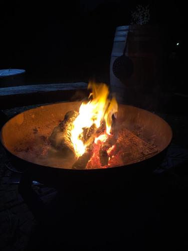 a large grill with fire in it at night at Agriturismo Pranu in Sorgono
