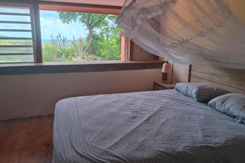 Postel nebo postele na pokoji v ubytování Maison créole Marguerite Rose