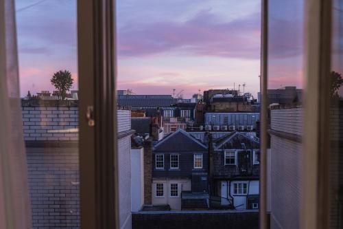 a view of a city skyline from a window at Althoff St James's Hotel & Club London in London