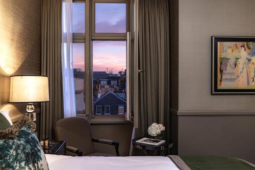 a hotel room with a bed and a window at Althoff St James's Hotel & Club London in London
