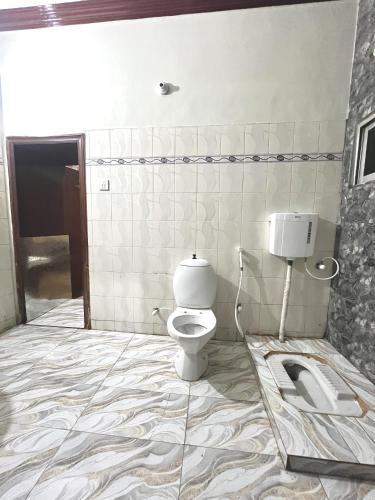 a bathroom with a toilet and a sink at Babar House in Faisalabad