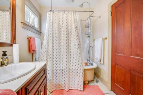 a bathroom with a shower curtain and a sink at Eau Claire Retreat Close to Campus and Dtwn! in Eau Claire