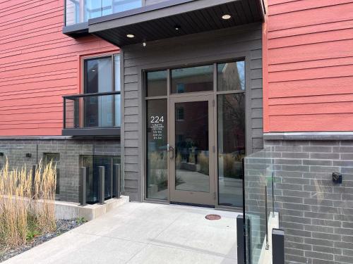a red building with a glass door on it at Modern Downtown Condo in Traverse City