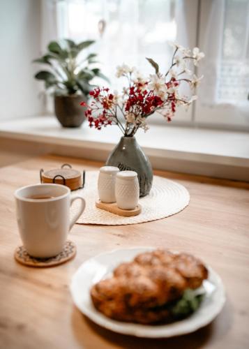 a table with a plate of food and a cup of coffee at Pohodička pod Verpánem in Batňovice