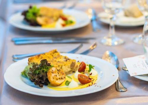 a white plate of food on a table at Hostería Valle Verde in Villa Alemana