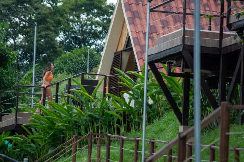 a woman walking down the stairs of a house at Pachakuti Eco-vida Hotel in Caicedonia