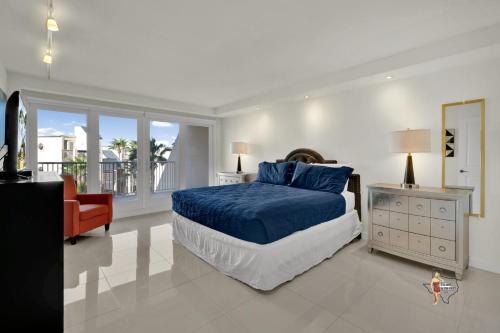 a bedroom with a bed and a chair and a window at Bahia Mar-Solare Tower, Beachfront Resort with Two Pools in South Padre Island