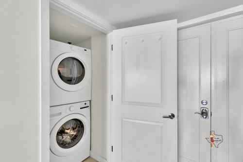 a white laundry room with a washer and dryer at Bahia Mar-Solare Tower, Beachfront Resort with Two Pools in South Padre Island