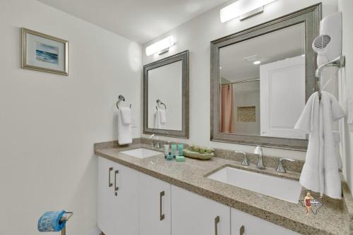 a bathroom with two sinks and a large mirror at Bahia Mar-Solare Tower, Beachfront Resort with Two Pools in South Padre Island