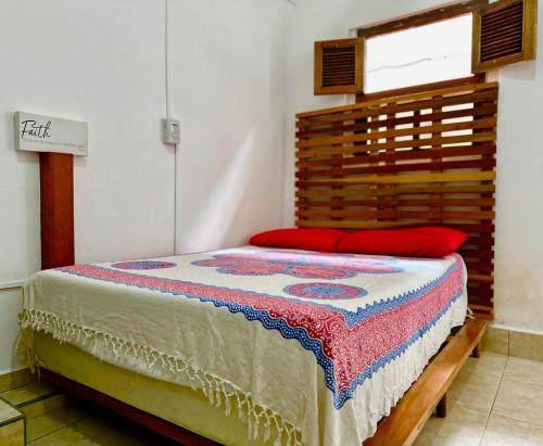 a bedroom with a bed with a wooden headboard at Casa Yoly Hostel Granada in Granada