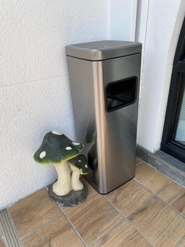 a trash can with two mushrooms next to it at 大溪漁港蜜月灣Luna民宿2號館 in Toucheng