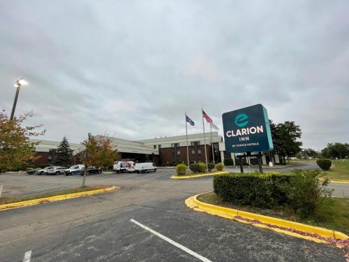a sign in front of a building with a car dealership at Clarion Inn I-94 near Expo Center in Kalamazoo