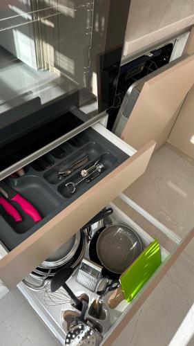 a drawer in a kitchen with tools in it at Apartments in center of Chisinau Anestiade in Chişinău