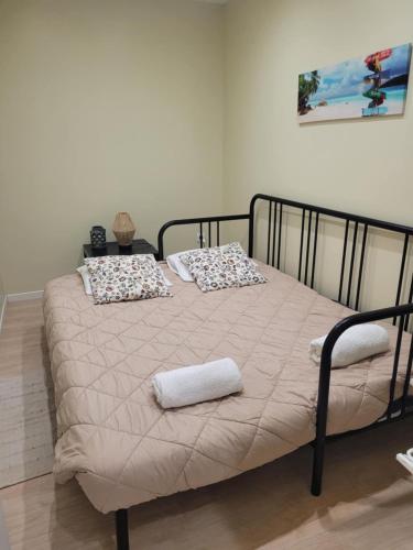 a bed with two pillows on it in a room at Casa da Aldeia in Monsaraz