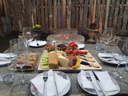 a table with a tray of food and wine glasses at Maksimilijan Winery Apartments & wine tasting in Pepelište