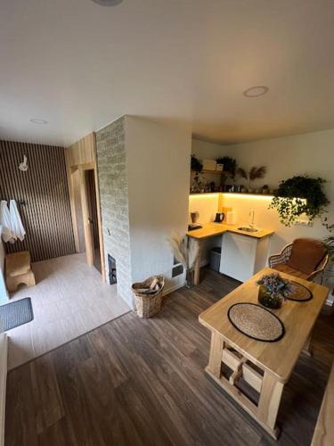 a living room with a table and a kitchen at Holiday Home Rubini in Līvi
