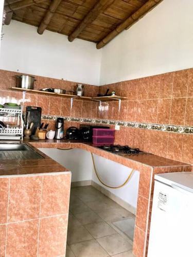 a kitchen with a counter top and a stove at Casa en las Nubes, Melgar Tolima in Melgar