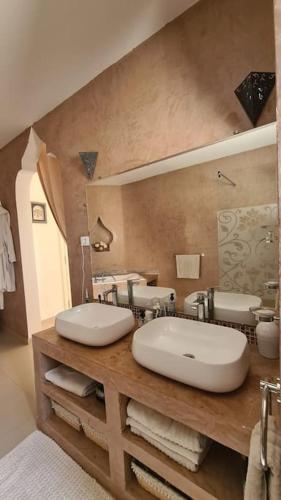 a bathroom with a sink and a large mirror at Villa Romana Monastir in Monastir