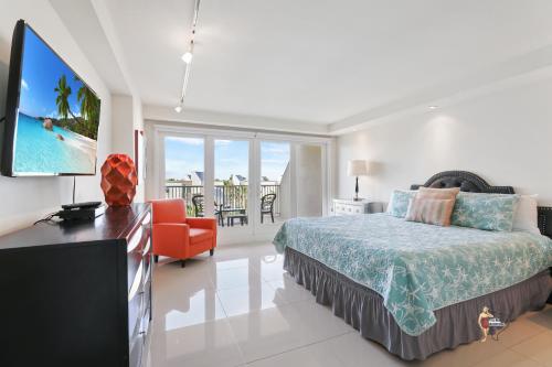 a bedroom with a bed and a flat screen tv at Bahia Mar-Solare Tower, Beachfront Resort with Two Pools in South Padre Island