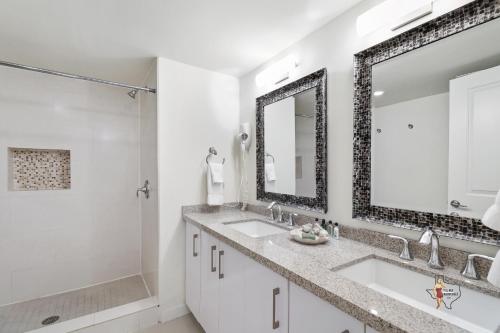 a bathroom with two sinks and a shower at Bahia Mar-Solare Tower, Beachfront Resort with Two Pools in South Padre Island