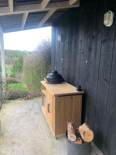 a wooden building with a stove on top of it at Super view Am Flachsberg in Butgenbach