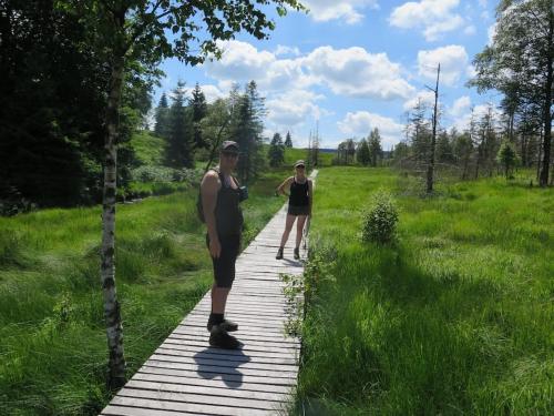 two people riding skateboards on a wooden path at Super view Am Flachsberg in Butgenbach