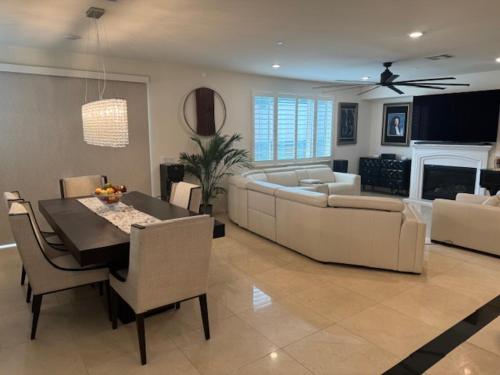a living room with a dining table and a couch at Elegant Retreat with Private Luxurious Gen Suite in Menifee