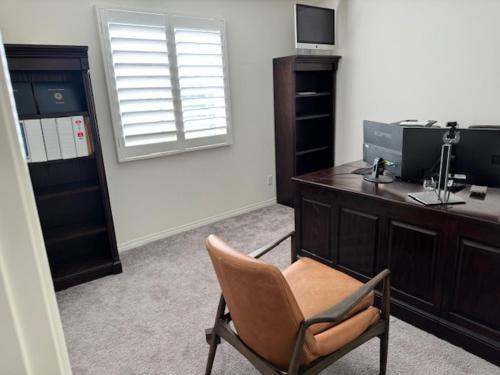 a office with a chair and a desk and a window at Elegant Retreat with Private Luxurious Gen Suite in Menifee