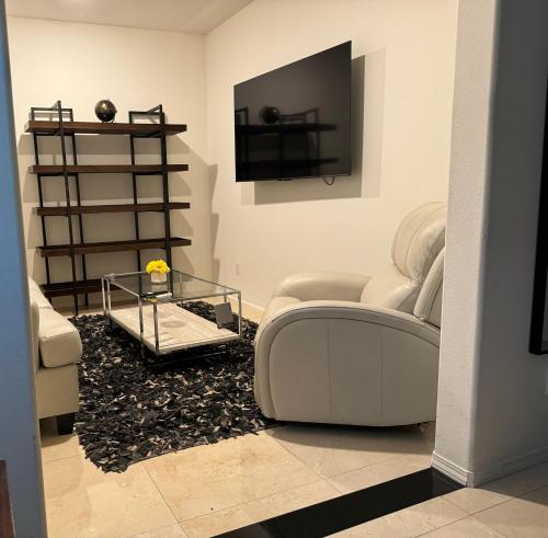 a living room with a couch and a tv at Elegant Retreat with Private Luxurious Gen Suite in Menifee