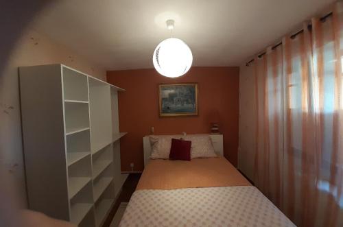 a small bedroom with a bed and a lamp at a patornay maison in Patornay