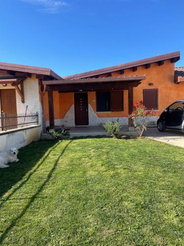 a house with a dog laying in the yard at Villa Frasia in Villa Grande