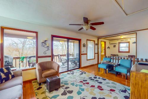 a living room with a couch and a ceiling fan at Highland Haven in Newland