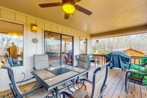 a table and chairs on a porch with a ceiling fan at Highland Haven in Newland