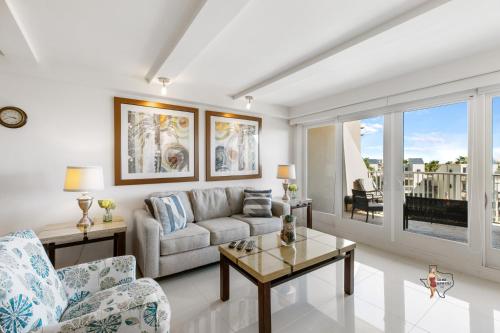 a living room with a couch and a table at Bahia Mar-Solare Tower, Beachfront Resort with Two Pools in South Padre Island