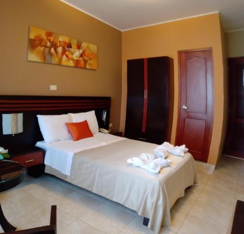 a bedroom with two beds with towels on them at Gran Hotel Ica in Ica