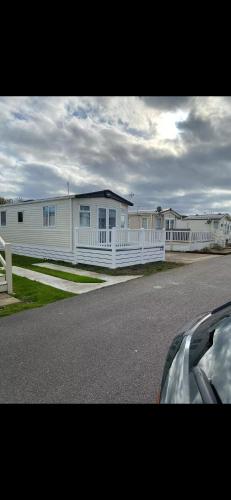 a row of white houses with a white fence at Luxury 6 Berth Holiday Caravan in Kent