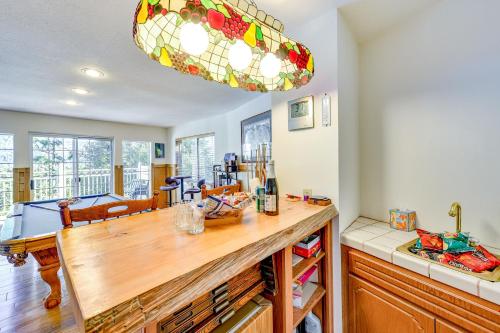 a kitchen with a table and a chandelier at Spacious Idyllwild Home with Mountain Views! in Idyllwild