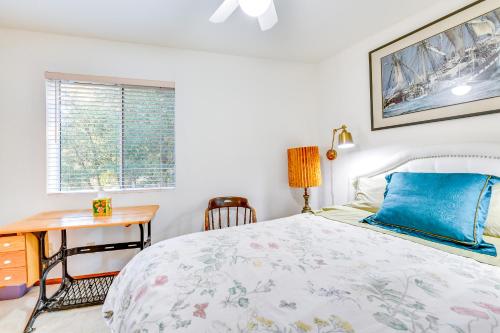 a bedroom with a bed and a desk and a window at Spacious Idyllwild Home with Mountain Views! in Idyllwild